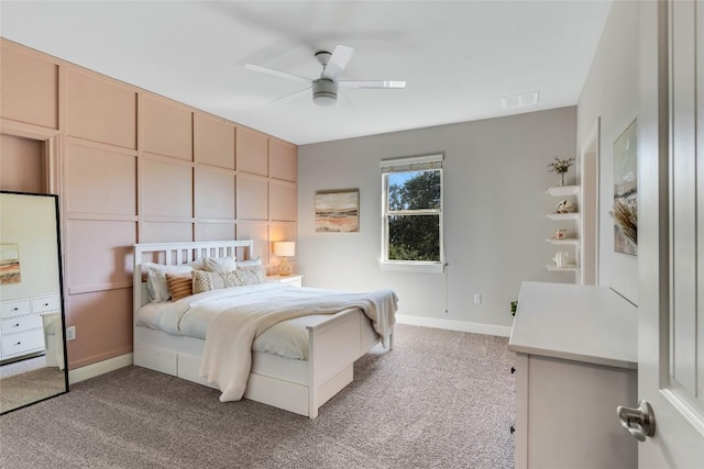 bedroom featuring a ceiling fan, light colored carpet, visible vents, and baseboards