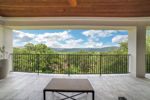 balcony featuring a ceiling fan and a mountain view