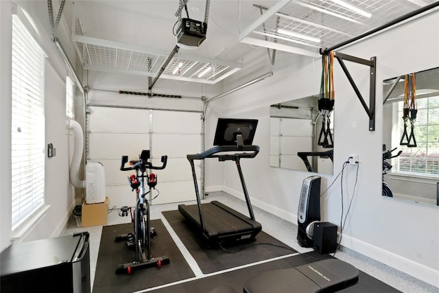 exercise area featuring a garage and baseboards