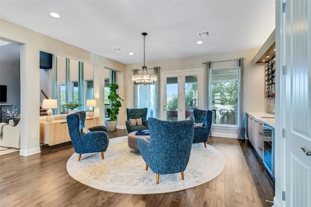 sitting room featuring recessed lighting, visible vents, and wood finished floors