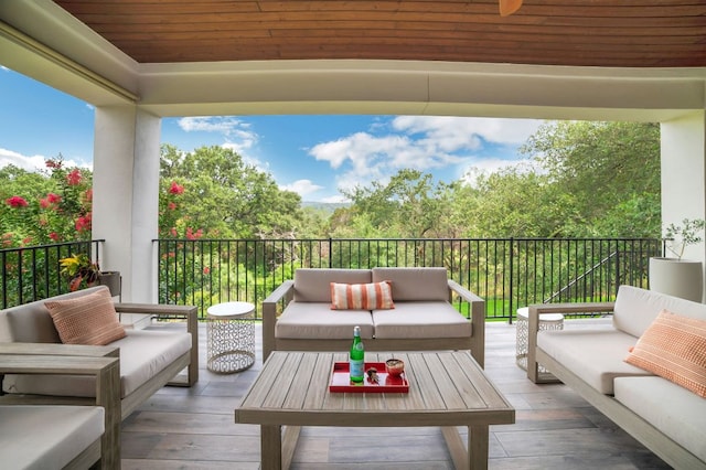 wooden deck featuring an outdoor hangout area and ceiling fan