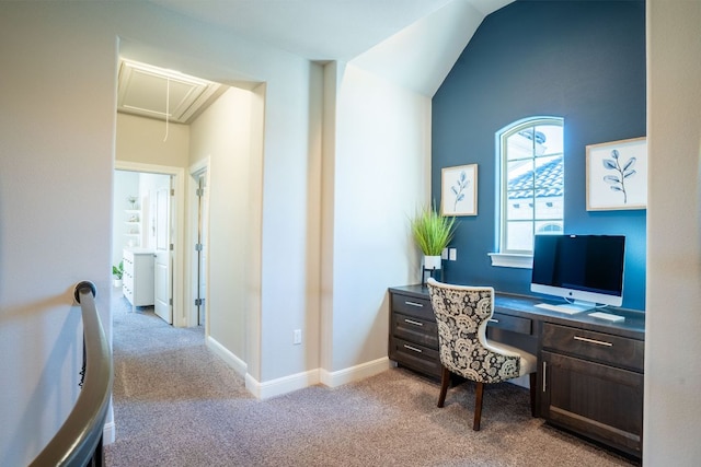 office with lofted ceiling, attic access, baseboards, and light colored carpet