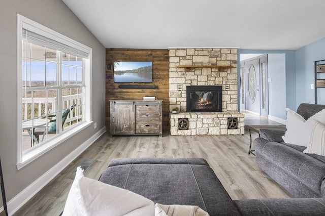 911 Sandy Mountain Dr, Sunrise Beach, TX 78643 - living room with a fireplace, plenty of natural light, baseboards, wood finished floors, and vaulted ceiling