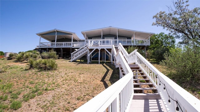 911 Sandy Mountain Dr, Sunrise Beach, TX 78643 - back of house featuring stairway