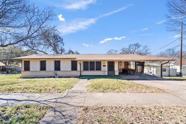 ranch-style house with concrete driveway and an attached carport