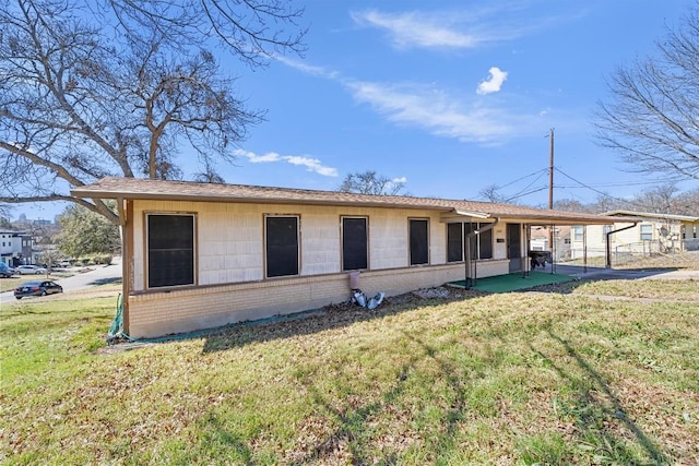 exterior space with a front lawn and brick siding