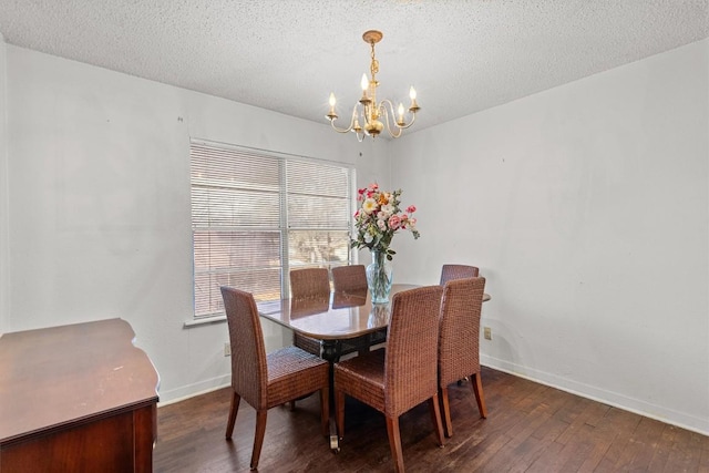 dining space featuring baseboards, dark wood-type flooring, a textured ceiling, and an inviting chandelier