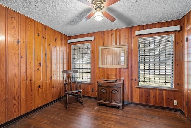 sitting room with a textured ceiling, dark wood-type flooring, and a wealth of natural light