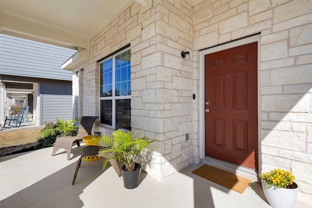 view of exterior entry featuring stone siding