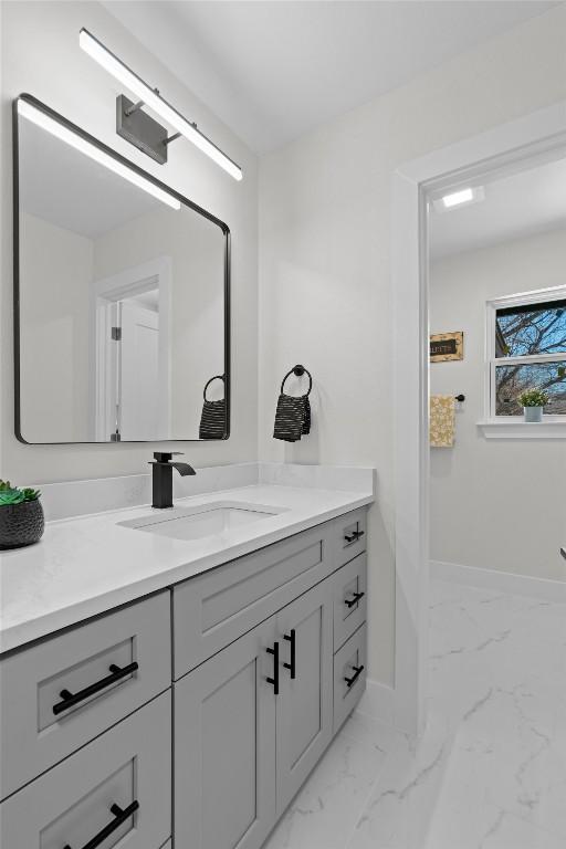 10505 Parkfield Dr, Austin, TX 78758 - bathroom with baseboards, marble finish floor, and vanity