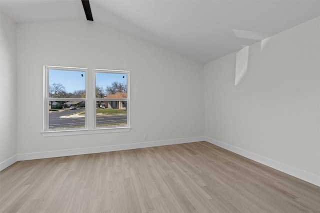 10505 Parkfield Dr, Austin, TX 78758 - empty room featuring lofted ceiling with beams, light wood-style flooring, and baseboards