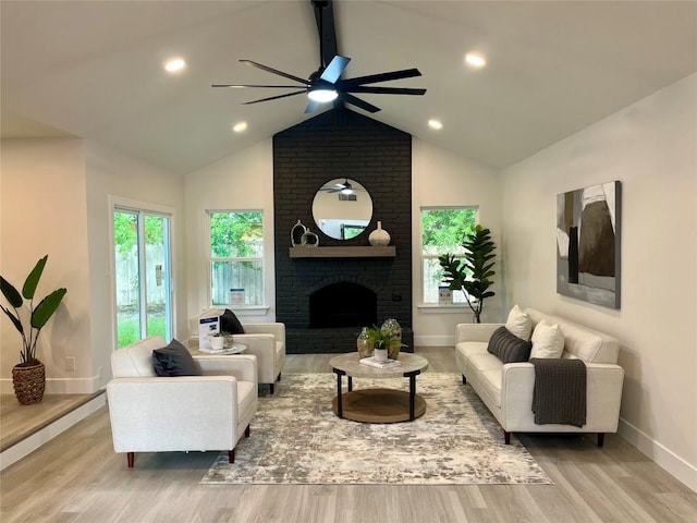 10505 Parkfield Dr, Austin, TX 78758 - living area featuring vaulted ceiling with beams, baseboards, a ceiling fan, wood finished floors, and a brick fireplace