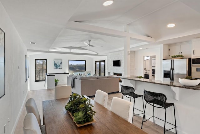 dining room featuring visible vents, baseboards, ceiling fan, light wood-style floors, and recessed lighting