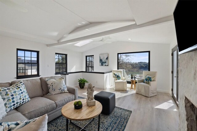 1201 Lake Shore Dr, Spicewood, TX 78669 - living area with wood finished floors, ceiling fan, and a skylight