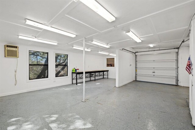 1201 Lake Shore Dr, Spicewood, TX 78669 - garage featuring a wall mounted air conditioner and baseboards