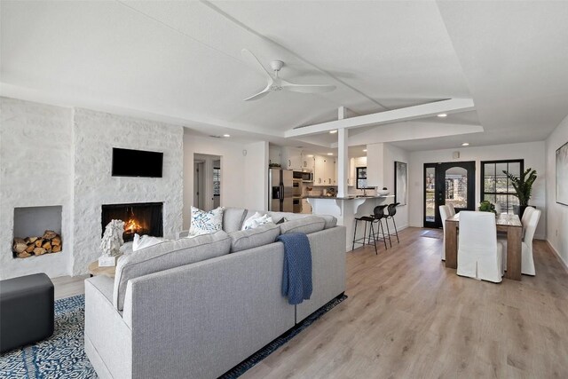 1201 Lake Shore Dr, Spicewood, TX 78669 - living area featuring ceiling fan, light wood finished floors, a large fireplace, and recessed lighting