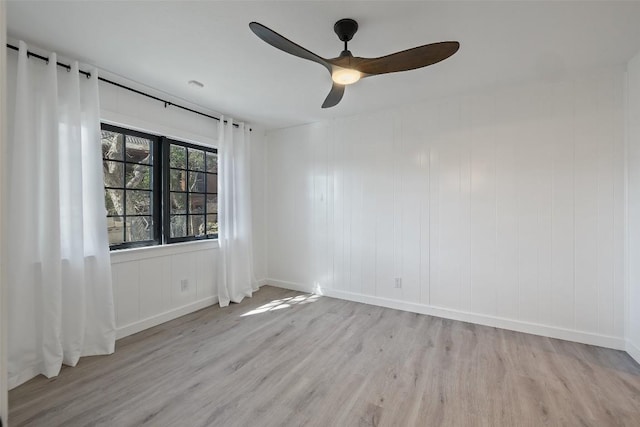 empty room featuring light wood-style flooring and a ceiling fan