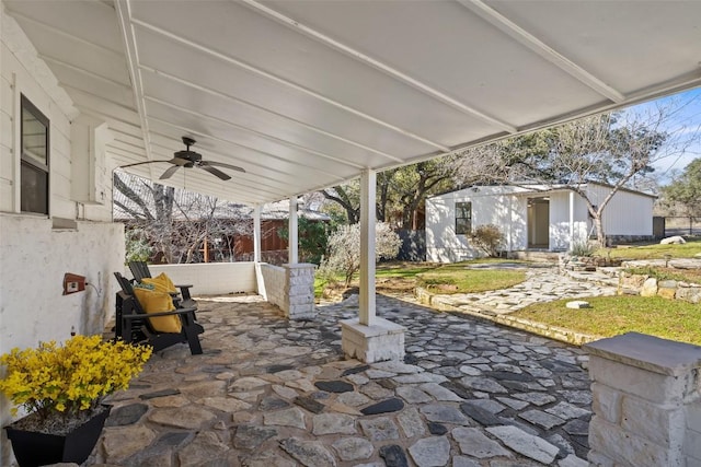 view of patio with a ceiling fan, an outbuilding, and a fenced backyard