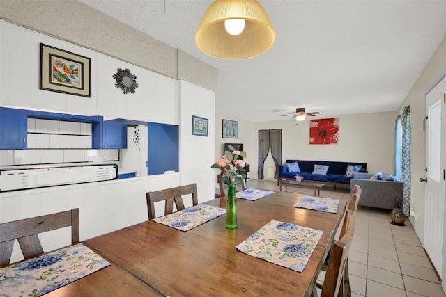 dining room with light tile patterned floors and ceiling fan