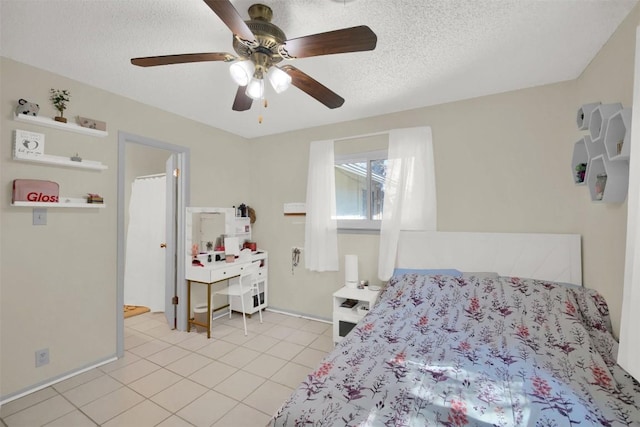 bedroom with light tile patterned flooring, ceiling fan, a textured ceiling, and baseboards