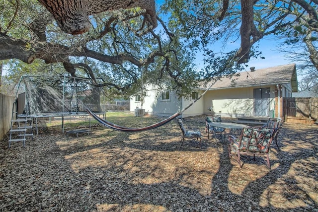 view of yard featuring a fenced backyard and a trampoline