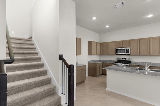2705 Sage Ranch Dr Unit 6, Leander, TX 78641 - kitchen with stainless steel appliances, light stone countertops, recessed lighting, a sink, and light tile patterned floors