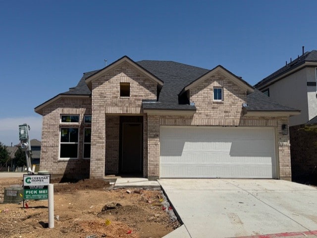 2705 Sage Ranch Dr Unit 6, Leander, TX 78641 - french country inspired facade featuring an attached garage, brick siding, and concrete driveway