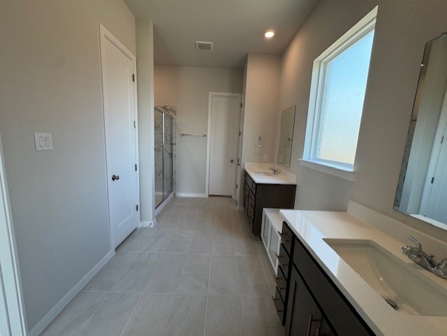2705 Sage Ranch Dr Unit 6, Leander, TX 78641 - full bathroom featuring two vanities, tile patterned floors, a shower stall, and recessed lighting