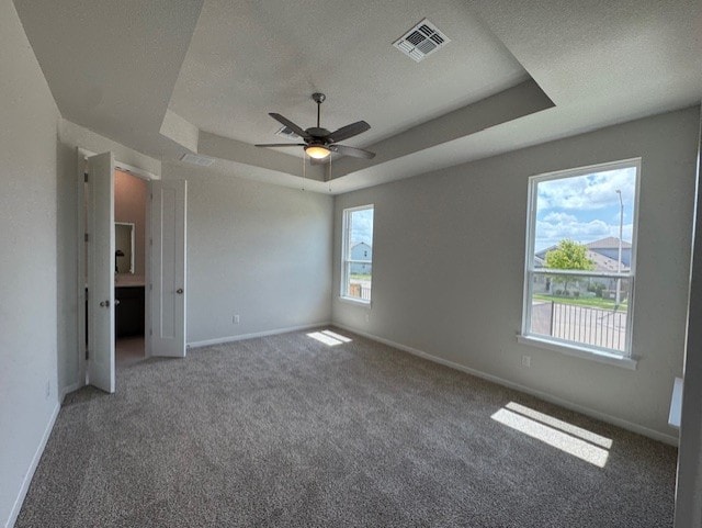 2705 Sage Ranch Dr Unit 6, Leander, TX 78641 - carpeted empty room featuring a tray ceiling, a textured ceiling, and a ceiling fan