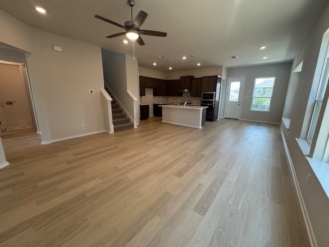 2705 Sage Ranch Dr Unit 6, Leander, TX 78641 - unfurnished living room with stairway, a ceiling fan, light wood-style floors, and recessed lighting