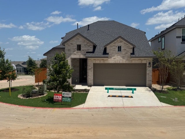 2705 Sage Ranch Dr Unit 6, Leander, TX 78641 - french country style house featuring brick siding, concrete driveway, and a front lawn