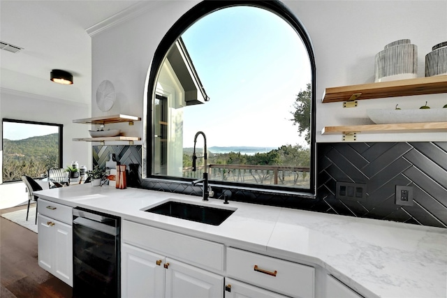 kitchen with wine cooler, a mountain view, a sink, white cabinets, and open shelves