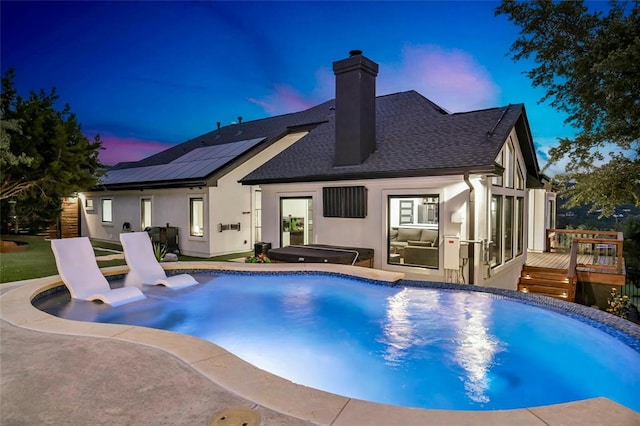 pool with a deck and a jacuzzi