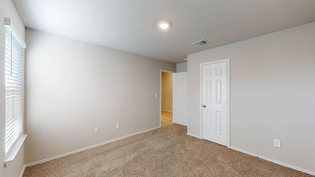 interior space featuring carpet floors and visible vents