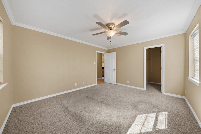 1206 Hi Stirrup Unit 311, Horseshoe Bay, TX 78657 - unfurnished bedroom featuring carpet flooring, a walk in closet, crown molding, a ceiling fan, and a closet