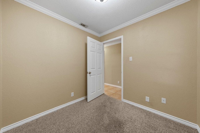 1206 Hi Stirrup Unit 311, Horseshoe Bay, TX 78657 - spare room featuring light carpet, ornamental molding, and a textured ceiling