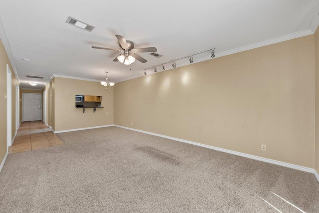 1206 Hi Stirrup Unit 311, Horseshoe Bay, TX 78657 - spare room featuring light carpet, rail lighting, a ceiling fan, and crown molding
