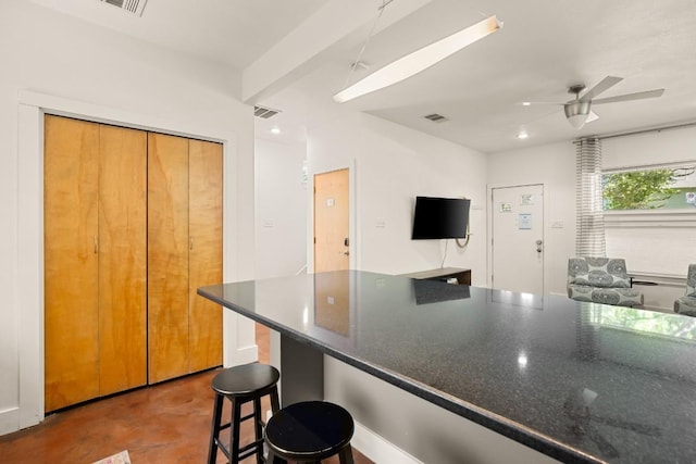 1201 Taylor St, Austin, TX 78702 - kitchen with ceiling fan, a breakfast bar, concrete floors, and open floor plan