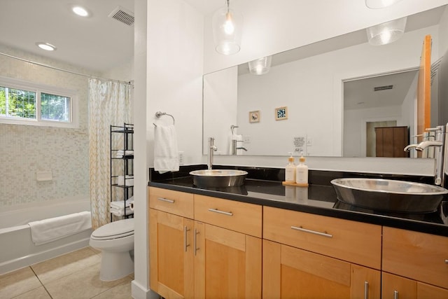1201 Taylor St, Austin, TX 78702 - full bath with tile patterned floors, double vanity, toilet, and shower / tub combo