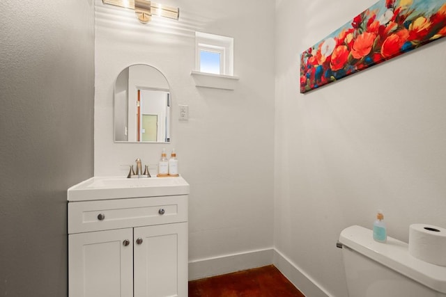 1201 Taylor St, Austin, TX 78702 - half bathroom featuring toilet, vanity, and baseboards