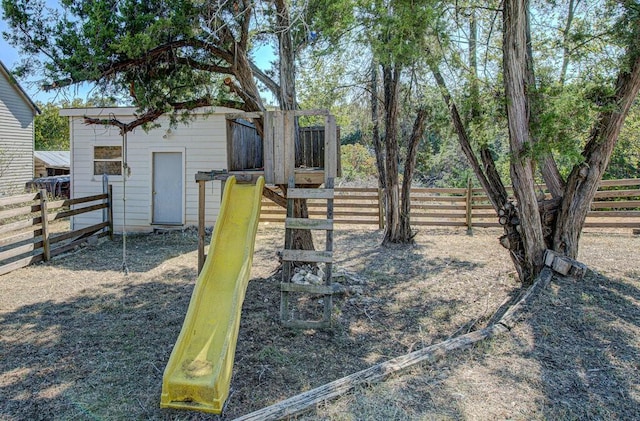 view of yard with a playground and fence