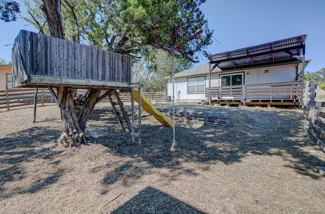 view of yard featuring fence and a wooden deck