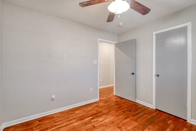 unfurnished bedroom featuring light wood finished floors, ceiling fan, and baseboards