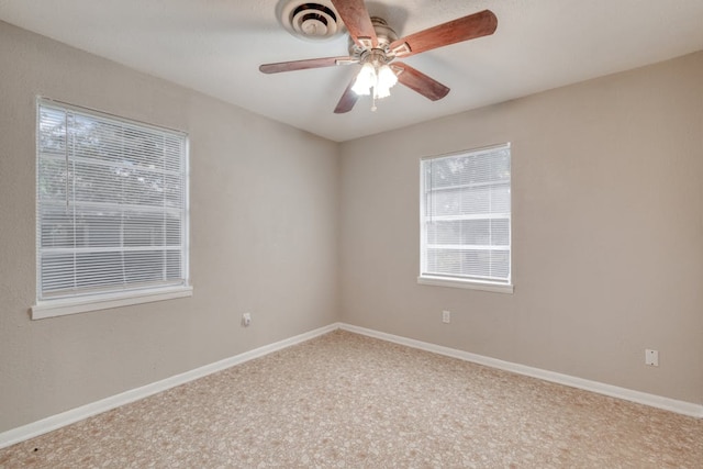 empty room with ceiling fan and baseboards