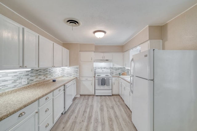 kitchen with tasteful backsplash, white appliances, white cabinets, and visible vents