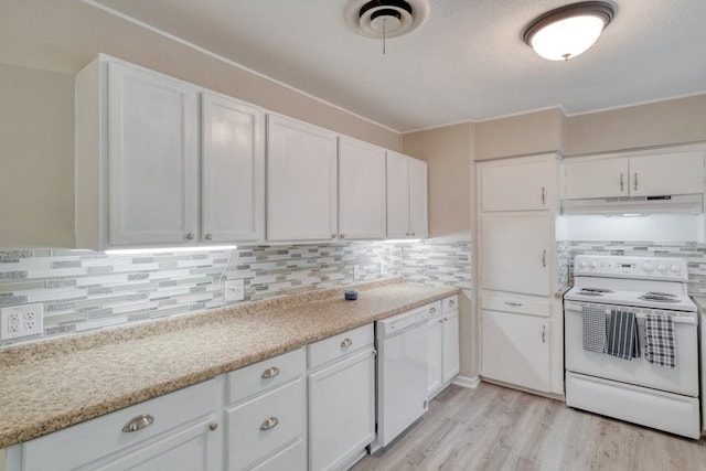 kitchen featuring white appliances, tasteful backsplash, white cabinets, light wood-style flooring, and under cabinet range hood