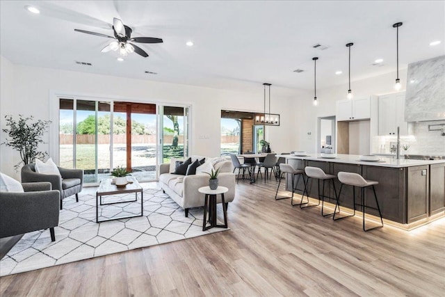 15400 Fm 1826, Austin, TX 78737 - living room with recessed lighting, light wood-style flooring, ceiling fan, and a chandelier
