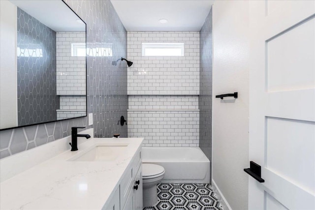 full bathroom featuring toilet, baseboards, tub / shower combination, and vanity