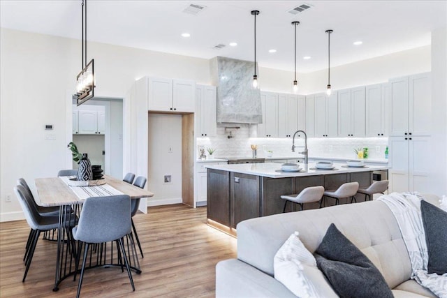 15400 Fm 1826, Austin, TX 78737 - kitchen featuring open floor plan, premium range hood, light wood-type flooring, decorative backsplash, and recessed lighting