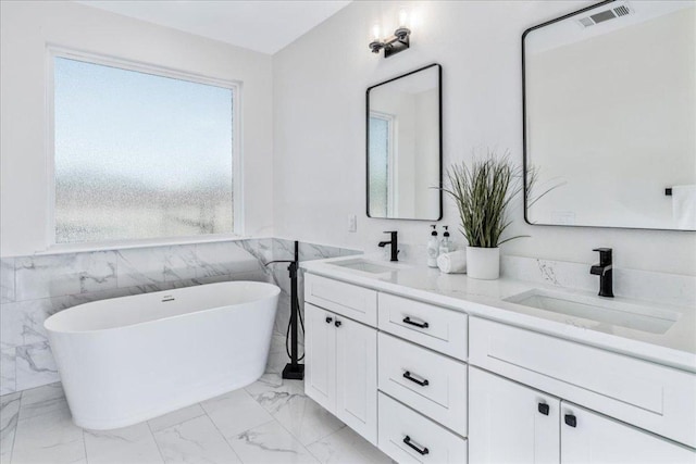 15400 Fm 1826, Austin, TX 78737 - full bath with double vanity, marble finish flooring, a freestanding bath, and wainscoting